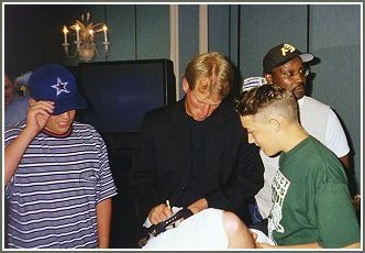 Rick Neuheisel signs for some fans